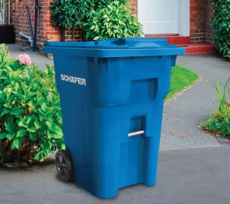 Schaefer waste bin positioned outdoors, featuring a durable container design for efficient waste collection, storage, and environmental service operations.
